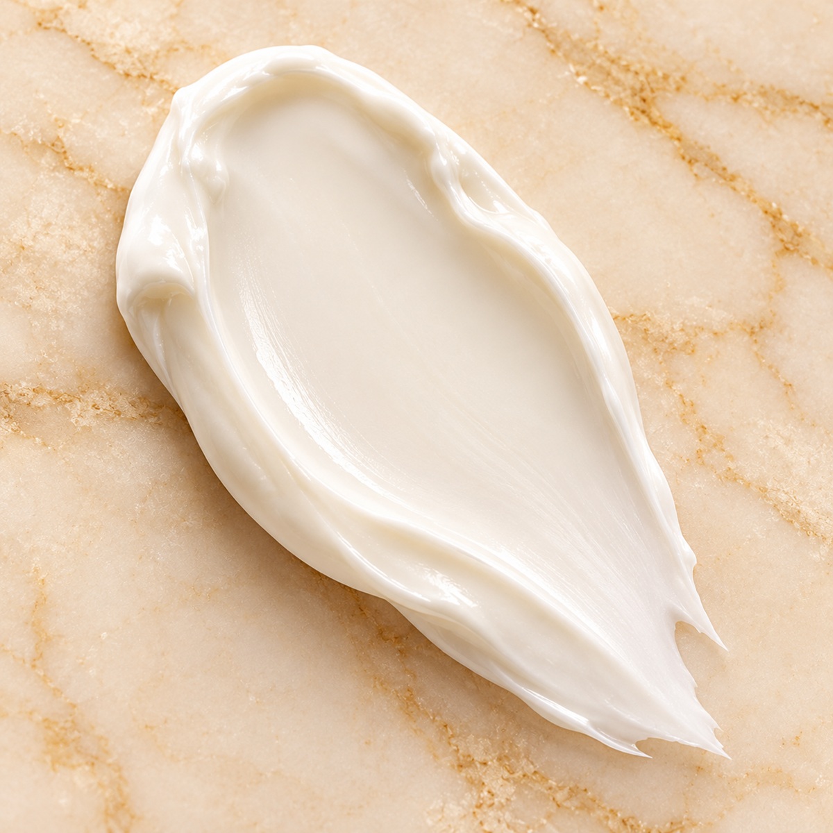 SeneGence EyeCrème ivory-white moisturizing cream texture swatch on champagne marble
