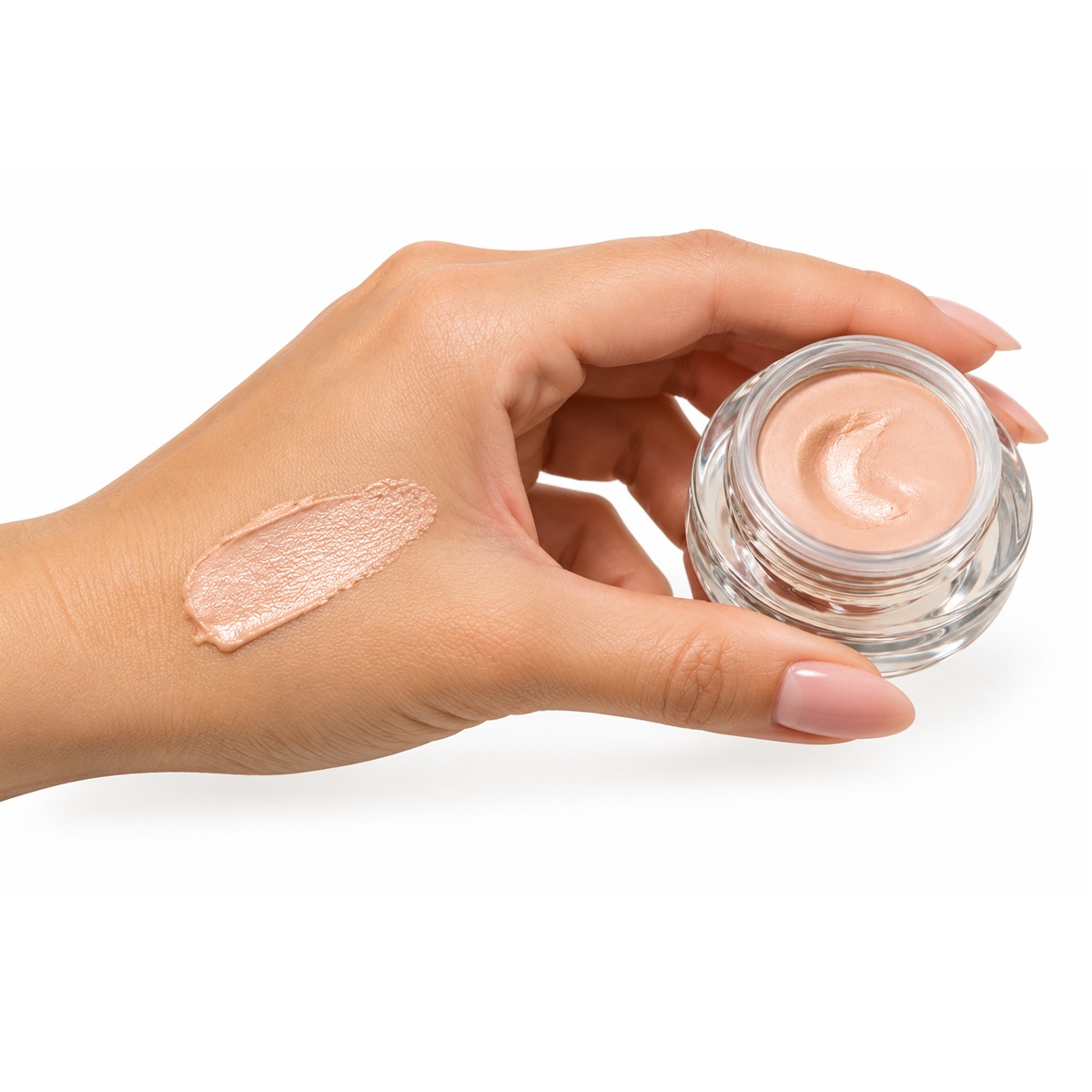 Horizontal hand swatch of SeneGence EyeLuminator Light with open glass jar showing peach-beige illuminating cream