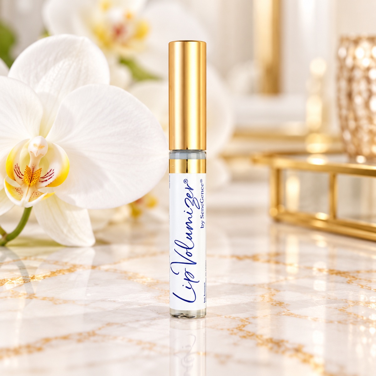 SeneGence LipVolumizer lip care serum with gold cap displayed on elegant marble beside white orchids